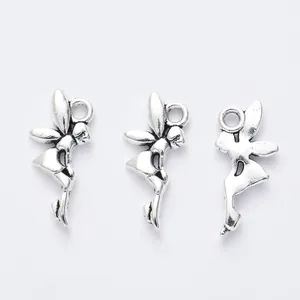 Macro detail of three vintage silver angel wing charms for DIY jewelry making crafts