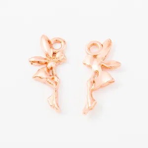 Detail of two rose gold fairy pendants with smooth finish and top loops for DIY jewelry