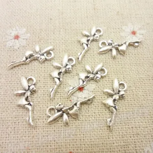 Detailed macro view of seven vintage silver alloy fairy pendants for DIY jewelry making