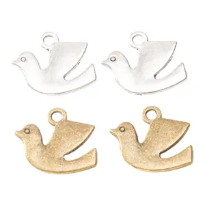 Set of four vintage alloy peace dove charms in antique silver and gold finishes
