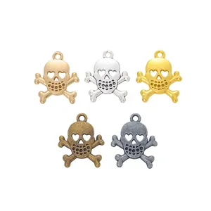 Set of five vintage alloy skull and crossbones pendants in assorted metallic finishes