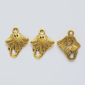 Macro view of vintage gold stingray alloy charms with textured detail for jewelry making