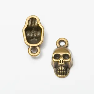 Vintage bronze skull charms in zinc alloy with detailed front and hollow back for DIY jewelry