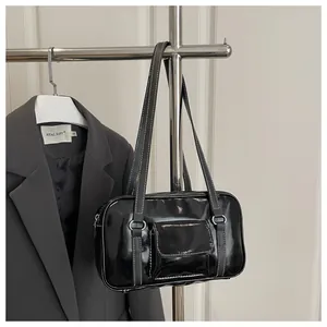 Detail of black glossy bowling bag with silver rings and front pocket on grey suit