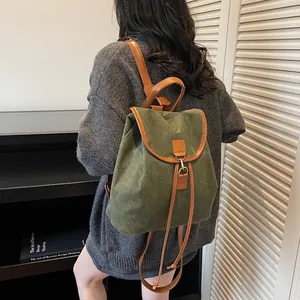 Retro dark green suede backpack with brown leather straps and drawstring closure