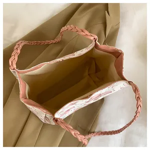 Top view of large tote bag with woven pink handles and spacious interior opening