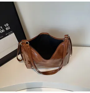 Top view of brown retro tote bag with zipper closure showing black lining and interior space