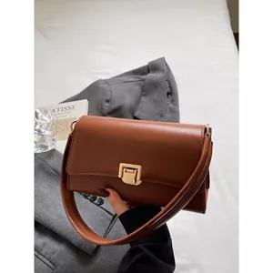 Classic brown baguette shoulder bag with gold square clasp and premium leather texture