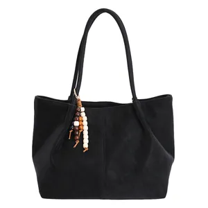 Classic black suede tote bag with decorative multicolored wooden bead tassel accent