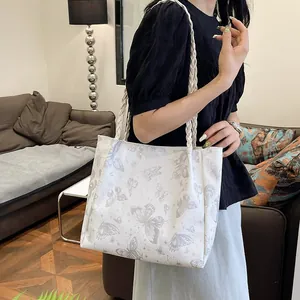 White large tote bag with grey butterfly print and stylish braided rope handles