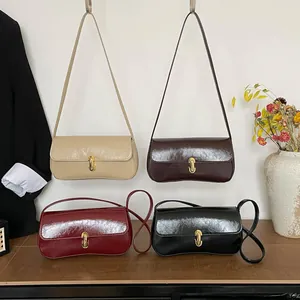 French style underarm bag in glossy oil-wax leather with elegant gold metal buckle closure
