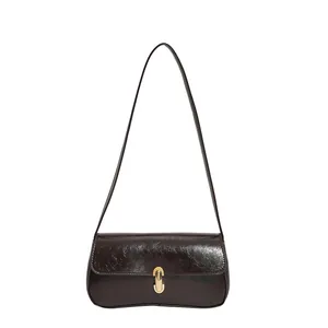 Retro deep brown glossy leather underarm bag with elegant golden metal clasp detail
