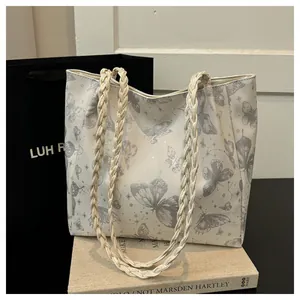 Cream tote bag with grey butterfly and star print featuring braided rope handles