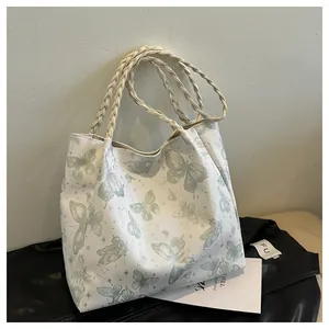 Fashionable white tote bag with green butterfly prints and woven rope shoulder straps