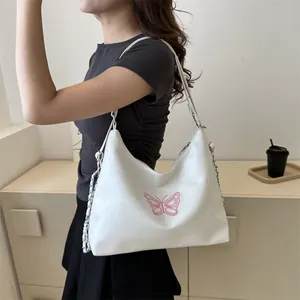 Chic white half-moon shoulder bag with pink butterfly embroidery and silver chain strap