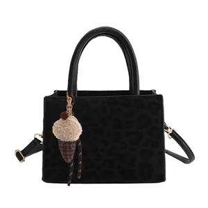 Black leopard embossed tote bag with luxury ice cream charm and adjustable strap