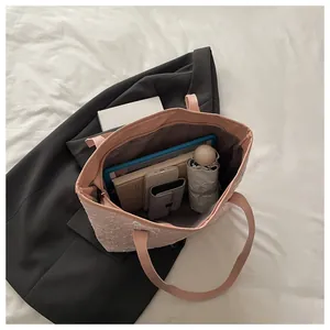 Interior view of a large pink tote bag showing spacious capacity for daily office items