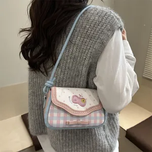Detail of pink and blue macaron lace shoulder bag featuring cherry patch and bow accent