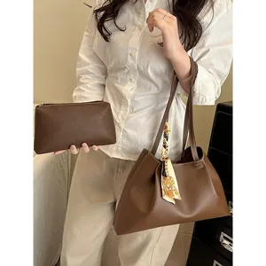 Brown faux leather tote bag with decorative silk scarf and matching inner pouch