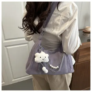 Detail of lavender hobo bag with cloud plush pendant and pearl chain decoration