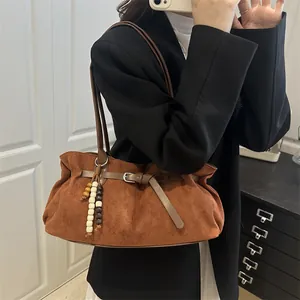 Retro caramel brown suede shoulder bag with pleated design and vintage wood bead charm