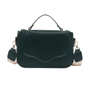 Dark green matte leather satchel bag with gold buckle and wide woven shoulder strap