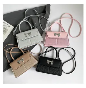 Detailed view of four stylish sequin handbags with bow metal buckles in multiple colors