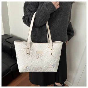 Quilted white leather tote bag with colorful butterfly embroidery and metal logo plate