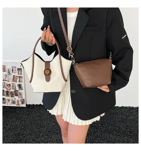 Detail shot of the cream and brown bucket bag set with its matching crossbody insert