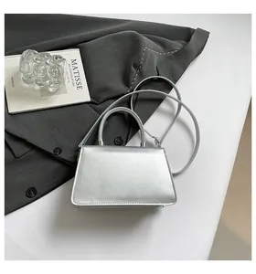 Silver bow accent metallic square handbag with detachable strap and smooth finish