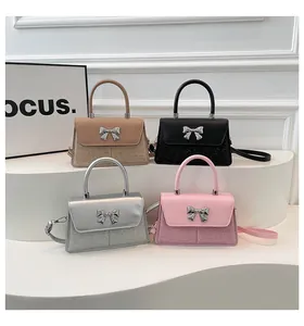 Detail of four colorful sequined trapezoid handbags with decorative silver metal bows