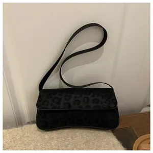 Chic black leopard print baguette bag with velvet texture and slim shoulder strap