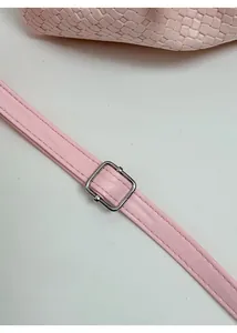 Close-up of pink woven texture bucket bag showing adjustable strap with silver buckle