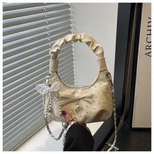 Chic pleated half-moon handbag in cream white with delicate pearl and bow details