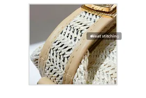 Detailed close-up of neat stitching and gold metal clasp on a straw woven handbag