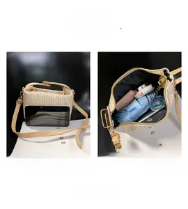 Detail showing the internal storage capacity of the beige straw shoulder bag