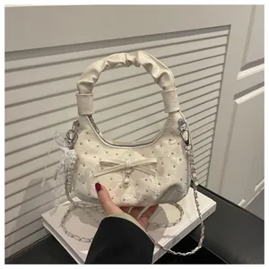 Creamy white crescent hobo bag with floral texture, elegant bow and pearl details