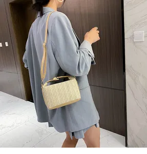 Detailed side view of a straw crossbody bag featuring woven texture and PU leather straps