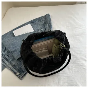 Top view of black drawstring bucket bag showing spacious interior with daily essentials