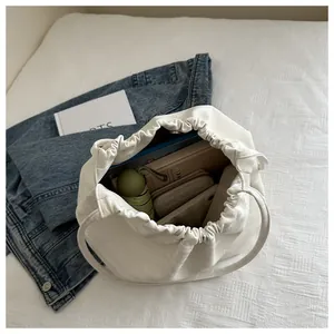 Internal view of a white drawstring bucket bag showing its spacious storage capacity