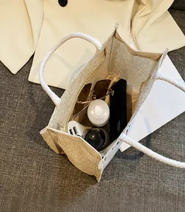 Binnenaanzicht van beige jute draagtas met opbergcapaciteit voor dagelijkse benodigdheden