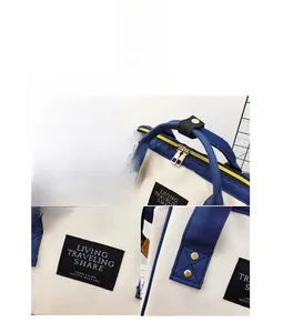 Detail of dual metal zippers and rivet reinforced handles on contrast diaper backpack