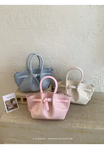 Detailed woven texture of stylish bucket bags in soft pink, beige, and light blue colors