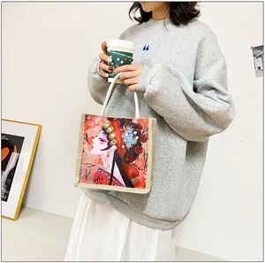Detail of jute tote bag featuring Chinese opera illustration and woven rope handles