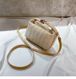 Close-up of woven straw bag with wavy texture and premium brown leather strap
