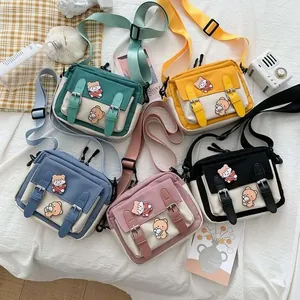 Five assorted canvas crossbody bags with cute bear embroidery and dual buckle straps