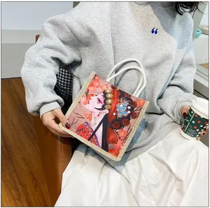 Detail of canvas handbag featuring ornate Beijing Opera lady print and woven rope handles