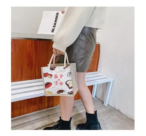 Close-up of a Japanese style canvas tote bag with bread illustration and woven rope handle