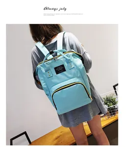 Close-up of stylish light blue diaper backpack with front pocket and contrast zippers