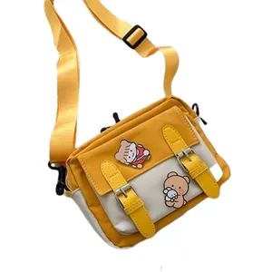 Cute yellow and white canvas crossbody bag with cartoon bear decor and adjustable strap